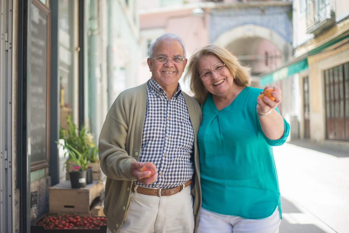Smiling Elderly Couple Buying Groceries